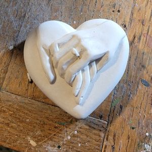 Hand holding in heart (plaster)